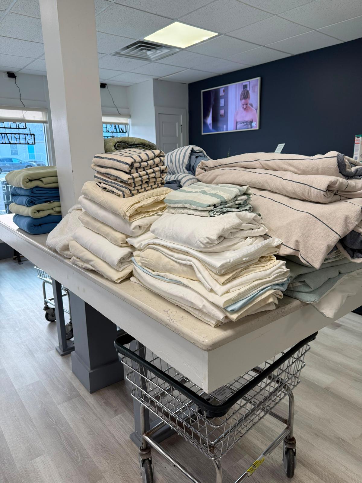 Freshly laundered and folded linens stacked on a table