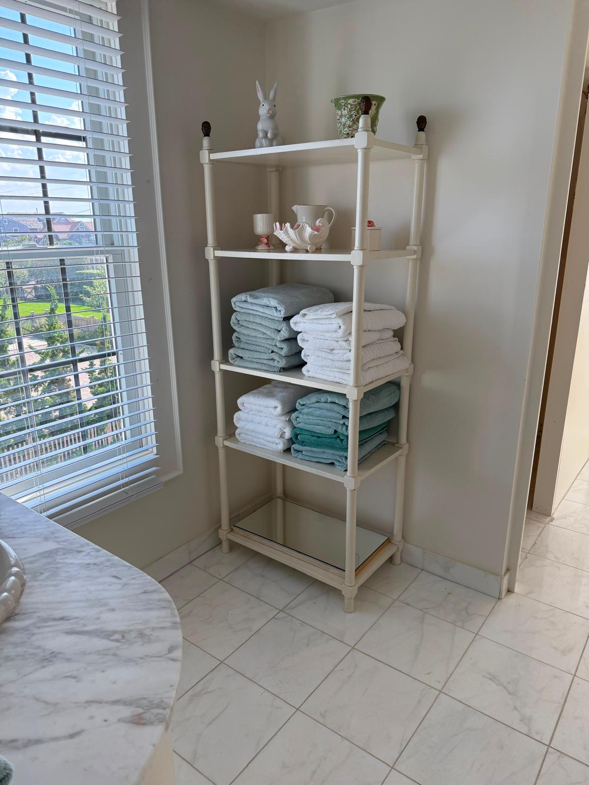 Neatly folded towels on bathroom shelving